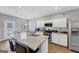 Modern kitchen with white cabinets, granite countertops, and stainless steel appliances at 11945 Lovejoy Crossing Way, Hampton, GA 30228