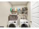 Laundry room with washer, dryer, and shelving at 11945 Lovejoy Crossing Way, Hampton, GA 30228