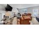 Living room with fireplace, large TV and comfy seating at 11945 Lovejoy Crossing Way, Hampton, GA 30228