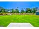 Landscaped backyard with large grassy area at 303 Roundwood Way, Peachtree City, GA 30269