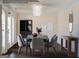 Modern staged dining room, featuring a dark wood table and gray chairs at 303 Roundwood Way, Peachtree City, GA 30269