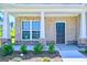 Covered front porch with stone accents and a dark-colored front door at 303 Roundwood Way, Peachtree City, GA 30269