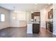 Modern kitchen with an island, stainless steel appliances, and dark brown cabinets at 303 Roundwood Way, Peachtree City, GA 30269