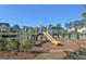 Community playground with modern equipment at 303 Roundwood Way, Peachtree City, GA 30269