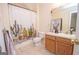 Bathroom with a cactus-themed shower curtain and vanity at 74 Canterbury Dr, Grantville, GA 30220