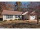 Brick ranch house with attached garage and landscaping at 74 Canterbury Dr, Grantville, GA 30220