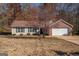 Brick ranch house with attached garage and a well-maintained lawn at 74 Canterbury Dr, Grantville, GA 30220