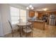 Eat-in kitchen with light wood cabinets and a breakfast bar at 74 Canterbury Dr, Grantville, GA 30220