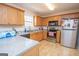 Kitchen with light wood cabinets, granite countertops, and stainless steel appliances at 74 Canterbury Dr, Grantville, GA 30220