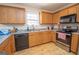 Kitchen boasts light wood cabinets, granite countertops, and stainless steel appliances at 74 Canterbury Dr, Grantville, GA 30220