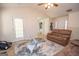 Living room with brown sofas, a ceiling fan, and access to the kitchen at 74 Canterbury Dr, Grantville, GA 30220