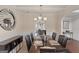 Formal dining room with dark wood table and leather chairs at 704 Kitts Ct, Mcdonough, GA 30253