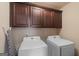 Laundry room with washer, dryer and upper cabinets at 704 Kitts Ct, Mcdonough, GA 30253