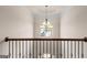 Elegant staircase with wrought-iron railings and chandelier at 704 Kitts Ct, Mcdonough, GA 30253