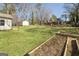 Backyard with raised garden beds and green space at 3213 Woodlynne Way, Atlanta, GA 30340