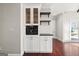 Built-in coffee bar with white cabinets and dark countertop at 3213 Woodlynne Way, Atlanta, GA 30340