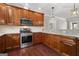 Modern kitchen with wood cabinets, granite countertops and stainless steel appliances at 3213 Woodlynne Way, Atlanta, GA 30340