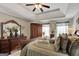 Main bedroom with tray ceiling, wood furniture and en suite bath at 123 Courtneys Ln, Fayetteville, GA 30215