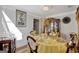 Formal dining room with a round table and yellow tablecloth at 123 Courtneys Ln, Fayetteville, GA 30215