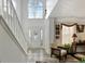 Two-story foyer with hardwood floors, staircase, and chandelier at 123 Courtneys Ln, Fayetteville, GA 30215