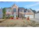 Brick two-story house with a two-car garage and landscaped lawn at 123 Courtneys Ln, Fayetteville, GA 30215