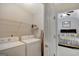 Bright laundry room with washer, dryer, and shelving at 123 Courtneys Ln, Fayetteville, GA 30215