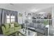 Open living area with green and gray sofas and kitchen view at 123 Courtneys Ln, Fayetteville, GA 30215