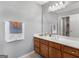 Primary bathroom with wood vanity and large mirror at 1598 Thornwick Trce, Stockbridge, GA 30281