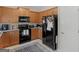 Kitchen with wood cabinets, black appliances and gray countertops at 1598 Thornwick Trce, Stockbridge, GA 30281