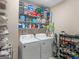 Laundry room with washer, dryer, and ample storage shelves at 1598 Thornwick Trce, Stockbridge, GA 30281