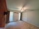 Bright bedroom featuring carpet, ceiling fan, and double windows at 1753 Brenda Dr, Jonesboro, GA 30236