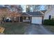 Brown siding house with white garage door and driveway at 122 Oak S Cir, Stockbridge, GA 30281