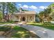Attractive single-Gathering home with a well-manicured lawn, welcoming front porch, and mature trees at 3806 Bill Gardner Pkwy, Locust Grove, GA 30248