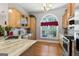 Bright kitchen with stainless steel appliances, ample cabinets and hardwood floors at 3806 Bill Gardner Pkwy, Locust Grove, GA 30248