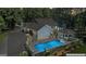 Stunning aerial view of a home with a private backyard oasis, pool, and gazebo at 3806 Bill Gardner Pkwy, Locust Grove, GA 30248