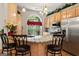 Well-lit kitchen featuring stainless steel appliances, ample counter space and hardwood floors at 3806 Bill Gardner Pkwy, Locust Grove, GA 30248