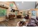 Open-concept living space with rustic wood walls, vaulted ceiling, and comfortable seating at 3806 Bill Gardner Pkwy, Locust Grove, GA 30248