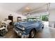 Spacious garage featuring classic cars and ample storage space, perfect for car enthusiasts at 3806 Bill Gardner Pkwy, Locust Grove, GA 30248