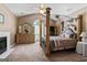 Spacious main bedroom with a king bed, fireplace, and vaulted ceilings at 3806 Bill Gardner Pkwy, Locust Grove, GA 30248