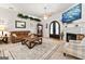 Inviting living room featuring a fireplace, ceiling fan, and stylish decor throughout at 3806 Bill Gardner Pkwy, Locust Grove, GA 30248