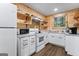 Efficient kitchen with white appliances, plenty of cabinet space, and natural light from the window at 3806 Bill Gardner Pkwy, Locust Grove, GA 30248