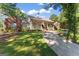 Inviting home with a charming front porch, lush lawn, and a curved driveway at 3806 Bill Gardner Pkwy, Locust Grove, GA 30248