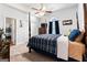 Cozy bedroom featuring a four-poster bed, ceiling fan, and closet at 3806 Bill Gardner Pkwy, Locust Grove, GA 30248