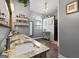 Bathroom with double sink vanity, granite countertops, and a walk-in shower at 3806 Bill Gardner Pkwy, Locust Grove, GA 30248