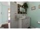 Stylish bathroom features rustic wood accents, modern sink with greenery, and soothing color palette at 3806 Bill Gardner Pkwy, Locust Grove, GA 30248