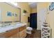 Bright bathroom featuring a vanity with granite counters and a wood-look floor at 3806 Bill Gardner Pkwy, Locust Grove, GA 30248