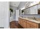 Bathroom featuring double sinks, granite countertops, and wooden floors at 3806 Bill Gardner Pkwy, Locust Grove, GA 30248