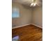 Hardwood floors, neutral walls, and a ceiling fan in this bedroom at 1310 Celia Way, Decatur, GA 30032