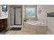 Bathroom featuring a corner soaking tub and shower at 101 Elite Way, Mcdonough, GA 30252