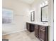 Double vanity bathroom with dark wood cabinets and tile flooring at 189 Aylesbury Blvd, Mcdonough, GA 30252